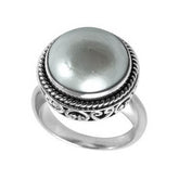 Sterling silver mother of pearl ring with polished cabochon stone, twisted rope bezel, and elegant Balinese scrollwork, handcrafted in Bali.